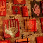 hand painted red group of hands on found and recycled wood,and vintage linoleum from the 1950's