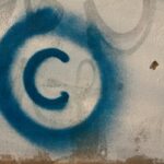 Large copyright graffiti sign on cream colored wall