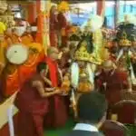 After the conversations two Oracles in ornate and heavy hats, mirror plates, khatags, Tibetan Buddhist lamas, and Gelugpa band playing music, Kalachakra for World Peace, Bodh Gaya, Bihar, India