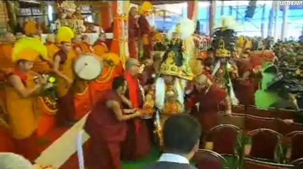 After the conversations two Oracles in ornate and heavy hats, mirror plates, khatags, Tibetan Buddhist lamas, and Gelugpa band playing music, Kalachakra for World Peace, Bodh Gaya, Bihar, India