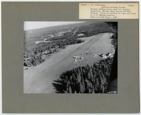 1950. Meacham landing strip, base for spraying operation, Meacham Unit. Western spruce budworm control project. Group of buildings on the right are those of U.S. Weather Station. Umatilla National Forest, Oregon.