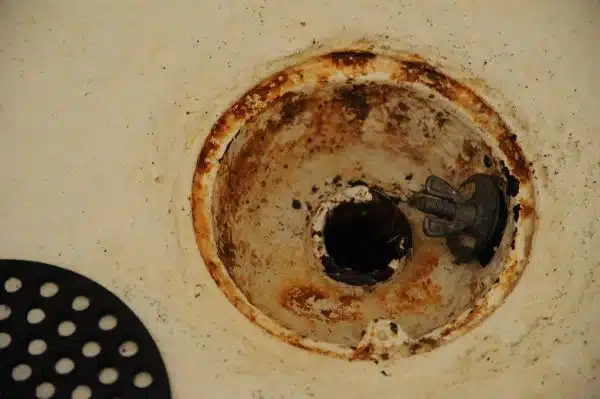 Rusty old style floor drain used as a shower drain, butterfly screw with metal and rubber plug, plumbing problems, Broadview, Seattle, Washington, USA