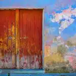 red wooden door of blue, red, and brown painted wall