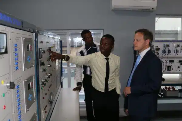 UK Minister for Africa and International Development, Grant Shapps MP, is shown a real-time solar electricity monitoring system in Lagos