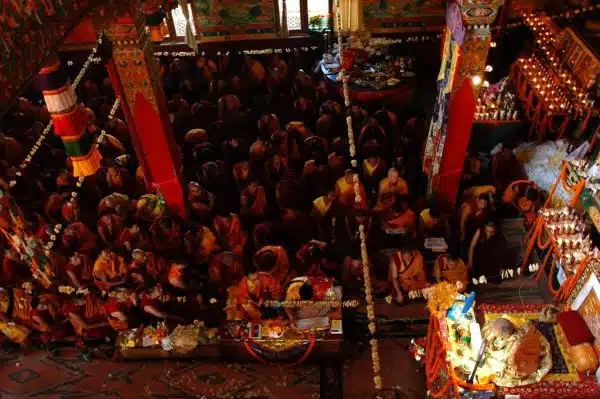 His Holiness Jigdal Dagchen Sakya leads the sangha in reflection on the initiation and vows, monks, lamas, students, shrine set up with formal offerings, flower seed pod decor, marigolds, Sakya Lamdre, Tharlam Monastery, Boudha, Kathmandu, Nepal