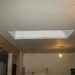 Double layer of plaster + drywall on ceiling to make it even. It also has a net impact of adding soundproofing and insulation