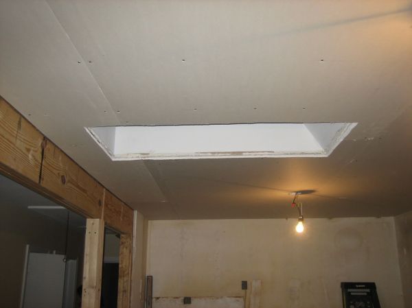 Double layer of plaster + drywall on ceiling to make it even. It also has a net impact of adding soundproofing and insulation