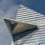 a tall building with a bird on the roof