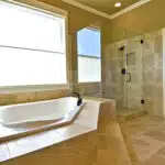 Travertine tile around tub and shower