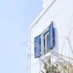 white concrete building with blue window